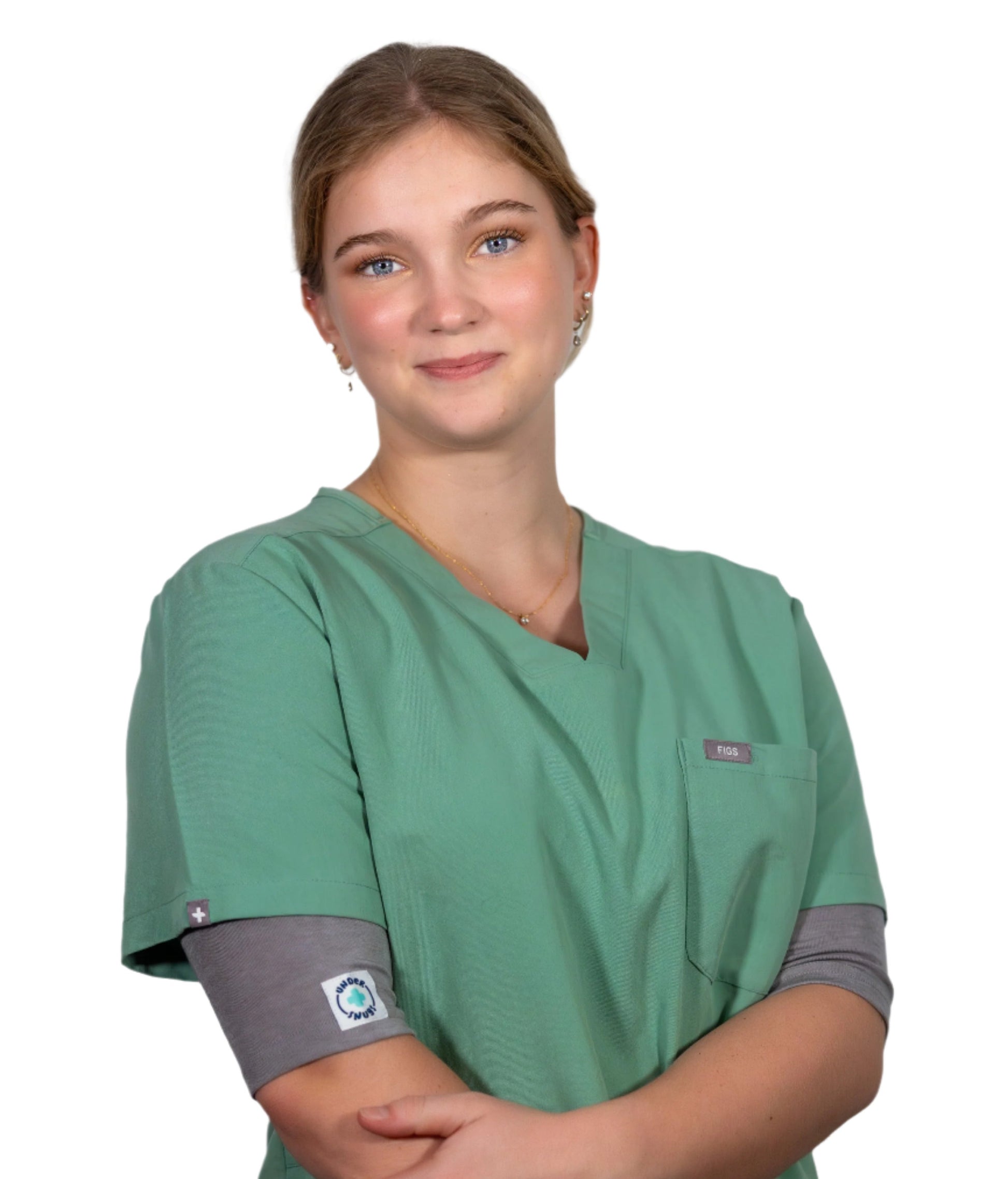 A young nurse smiling whilst wearing grey marle Under Scrubs under her green scrubs