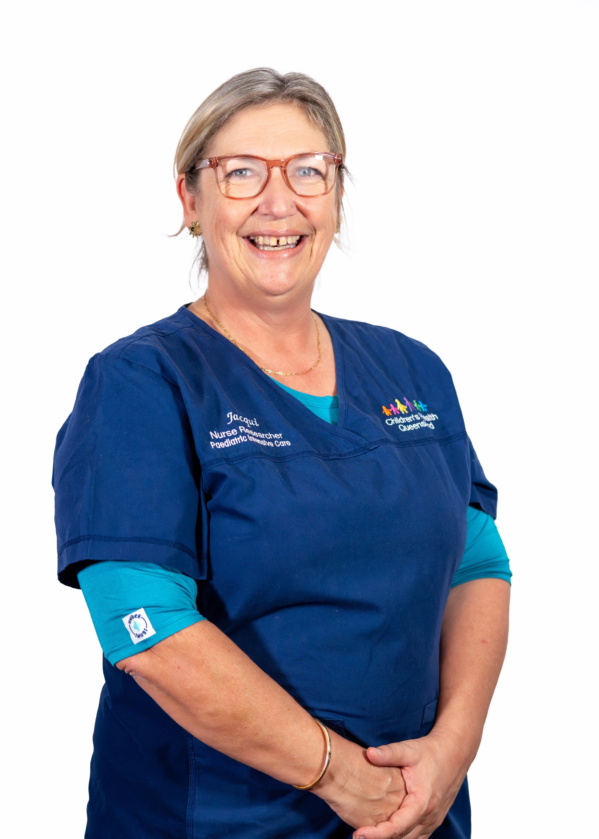 Jacqui - founder & designer of Under Scrubs who is also a nurse & academic - with a big smile on her face
