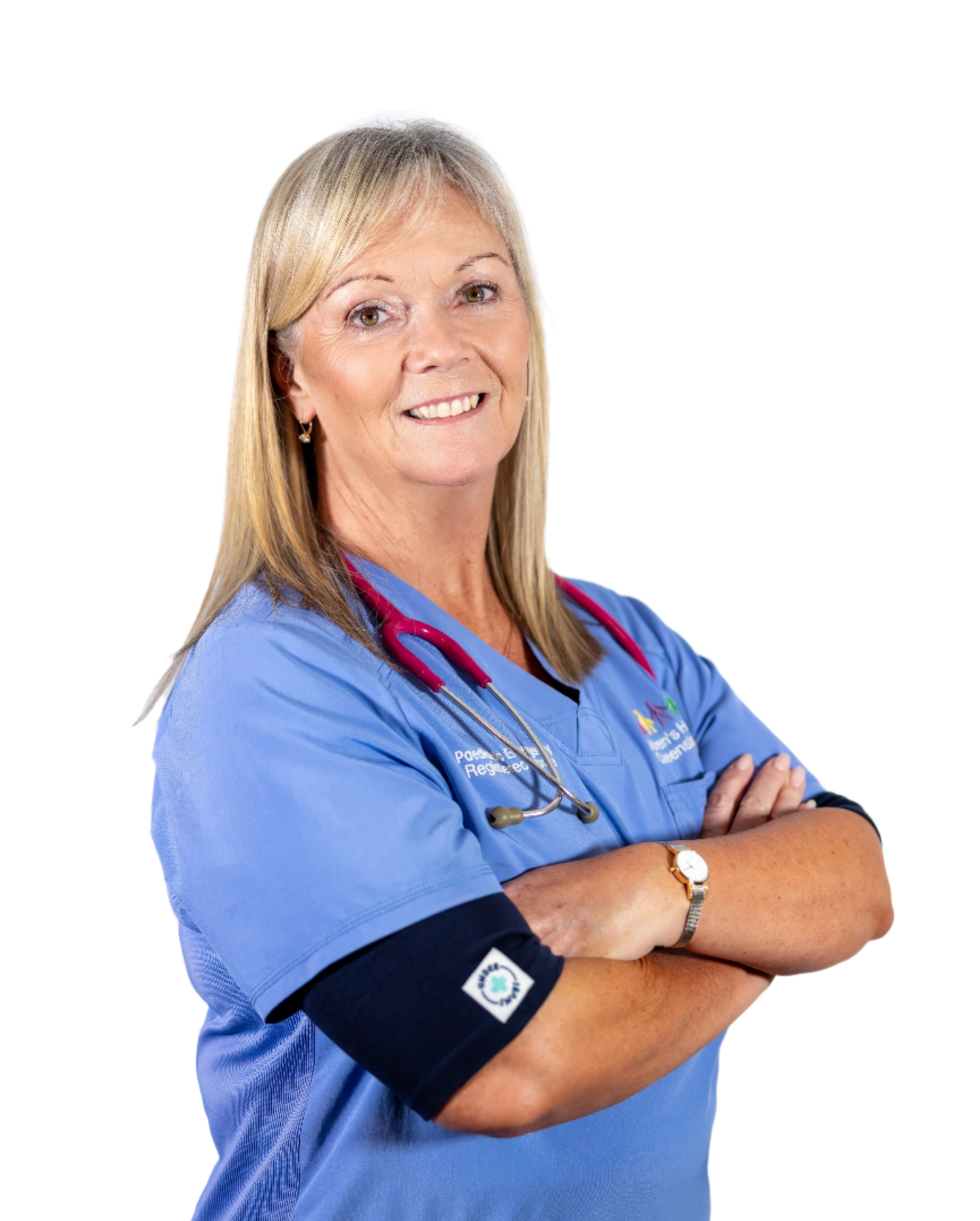 A middle-aged nurse with her arms crossed wearing a stethoscope, smiling & wearing a navy coloured Under Scrubs top under light blue scrubs